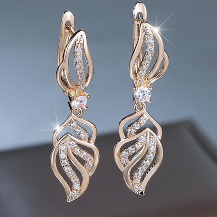 Luxury champagne gold leaf drop earrings with sparkling white crystal detailing for women.