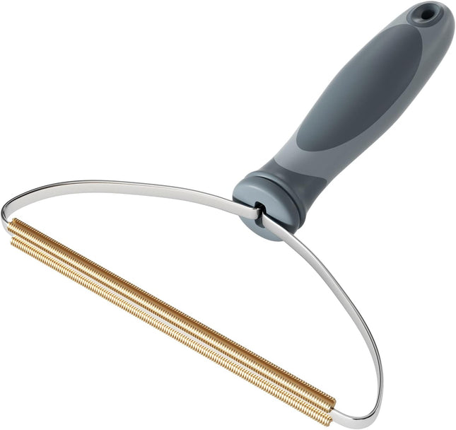 Cleaning brush with a gray handle and gold bristle head on a white background